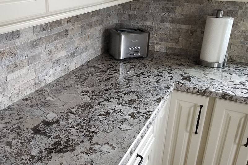 Granite kitchen coutnertop with toaster and paper towels in corner